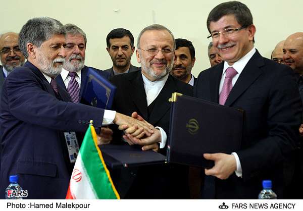 ایران، برازیل اور ترکی کے وزراے خارجہ ایٹمی ایندھن کے تبادلے پر معاہدہ طے ہونے پر ہاتھ ملاتے ہوئے