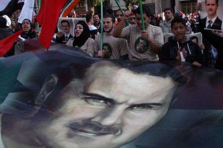 Thousands of Syrians demonstrate in Damascus in support of President Bashar al-Assad against the Arab League