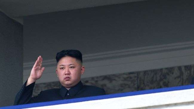 North Korean leader Kim Jong-Un salutes as he watches a military parade to mark 100 years since the birth of the country