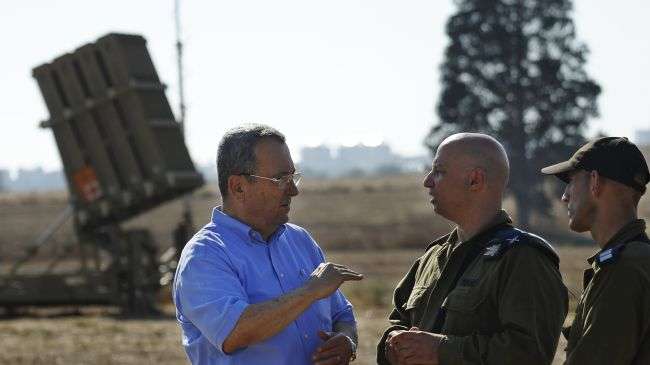 Israeli Minister for Military Affairs Ehud Barak (L) visits an Iron Dome launcher stationed close to the southern city of Ashkelon, August 21, 2011.