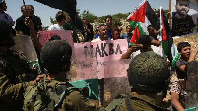 Palestinian protesters in the occupied West Bank confront Israeli troops during a demonstration ahead of the Nakba Day, May 12, 2012.