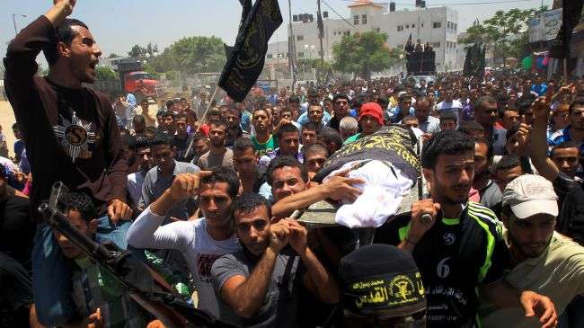 Mourners carry the body of a Palestinian killed in Israeli airstrikes on the northern Gaza Strip, June 18, 2012.