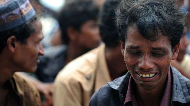 A Rohingya Muslim from Myanmar, who tried to cross the Naf river into Bangladesh to escape sectarian violence, cries after disembarking from an intercepted boat in Teknaf on June 18, 2012.