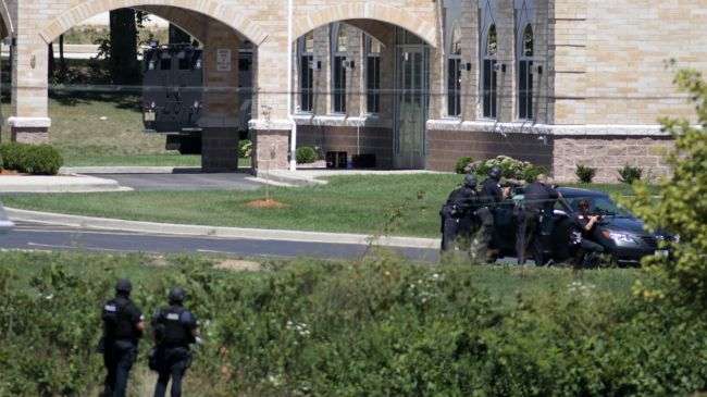 Police SWAT officers surround the Sikh temple in Oak Creek, Wisconsin where a gunman opened fire on a mass on August 5, 2012.