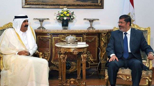 Egyptian President Mohamed Morsi (R) meeting with the Emir of Qatar, Sheik Hamad bin Khalifa Al-Thani, on August 11, 2012, at the Presidential Palace in the Egyptian capital, Cairo.