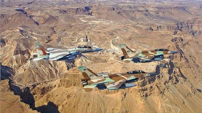 Three Israeli warplanes -- two F-16s and one F-15 -- fly in formation.