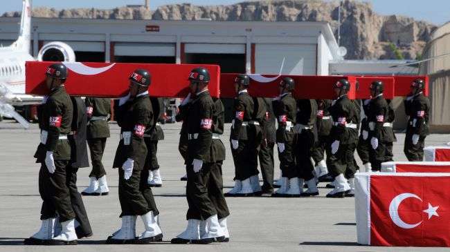 Turkish soldiers carry the coffins of soldiers killed in a PKK attack on June 19, 2012.