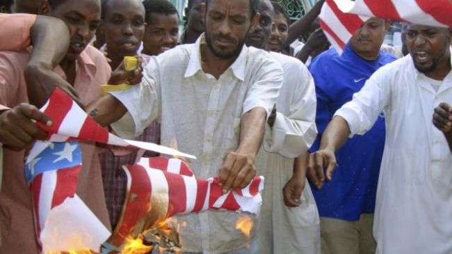 A group of Kenyan Muslims burn the US flag following afternoon prayers outside the Sakina Jamia Mosque in the port city of Mombasa, September 14, 2012.
