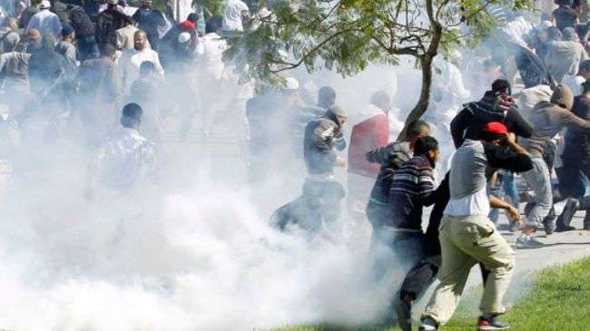 Protesters run for cover during a demonstration in front of the US Embassy in Tunis on September 14, 2012.