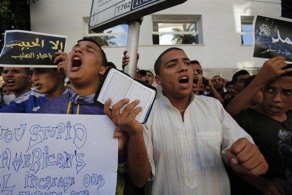 Demonstrators protest in front of the U.S. embassy in Casablanca September 14 2012 during a rally against the anti-Islam film produced in the United States and its portrayal of Prophet Mohammad. The placard on left reads: Do not touch the Prophet (Mohamm