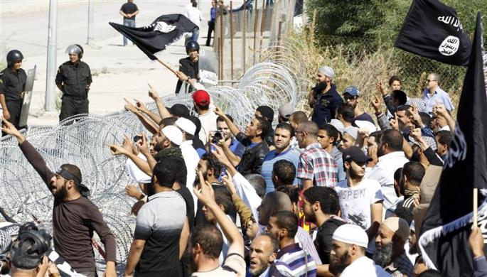 Protesters wave flags and shout slogans during a demonstration in front of the U.S. Embassy in Tunis September 14 2012.