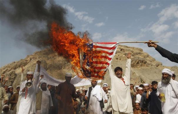 Afghan protesters burn a U.S. flag as they shout slogans during a demonstration in Jalalabad province September 14 2012. Hundreds of Afghans protested against a movie they say insults Prophet Mohammad.