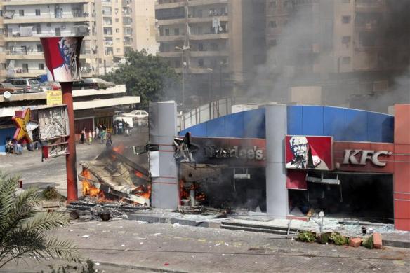 A Hardee and a Kentucky Fried Chicken (KFC) fast food outlet burns after protesters set the building on fire in Tripoli northern Lebanon September 14 2012.