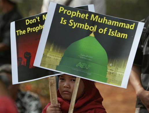 An Indonesian Muslim child holds placards during a protest in front of the U.S. embassy in Jakarta September 14 2012.