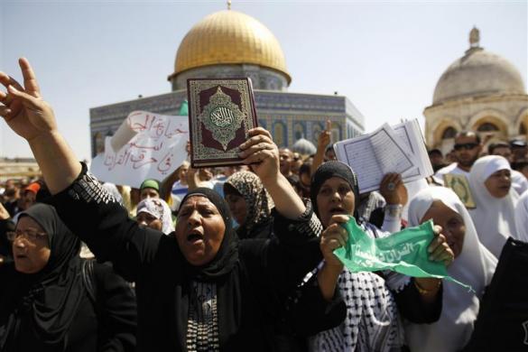 A Palestinian demonstrator holds a Quran during a protest after Friday prayers near the Dome of the Rock (rear) on the compound known to Muslims as Noble Sanctuary and to Jews as Temple Mount in Jerusalem Old City September 21 2012.
