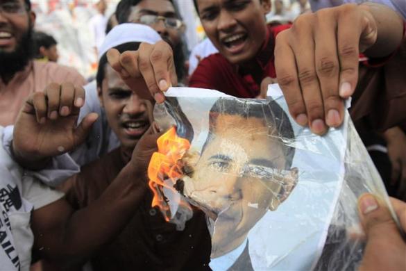 Bangladeshi Muslims burn a picture of President Barack Obama during a protest in front of the National Press Club in Dhaka September 21 2012.