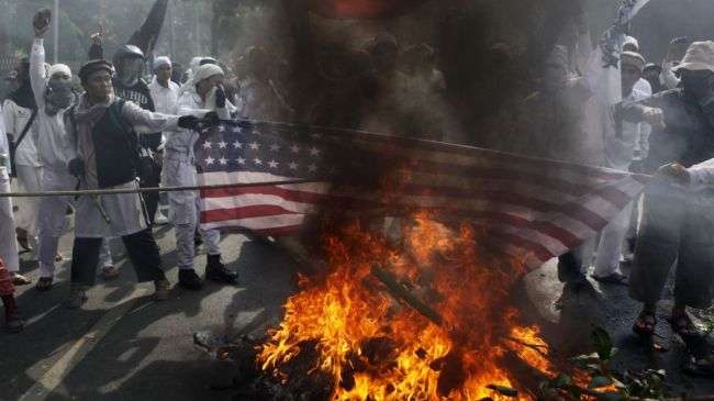 Muslim protesters burn a US flag during a protest against an anti-Islam movie outside the US Embassy in Jakarta, Indonesia, on September 17, 2012.