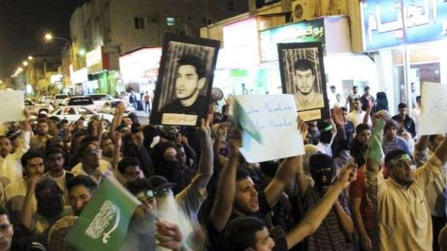 Saudi protesters hold portraits of political prisoners during an anti-regime demonstration in the Qatif region of Eastern Province, Saudi Arabia.