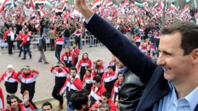 File photo shows Syrian President Bashar al-Assad at Umayyad Mosque in Damascus among Syrian people marching to express their support for his reforms, January 12, 2012.