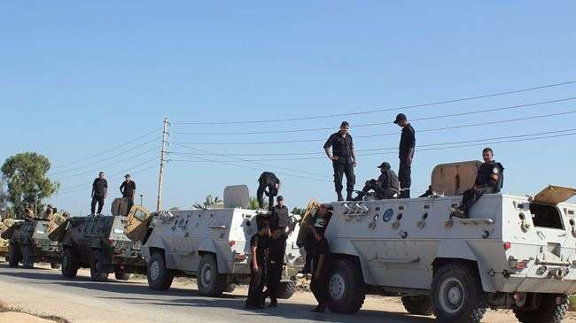 Egyptian security forces stand by their armoured personnel carrier ahead of a military operation in the northern Sinai Peninsula .