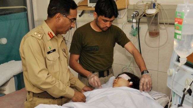 Pakistani army doctors treat Malala Yousafzai at an army hospital in Peshawar on October 9, 2012.