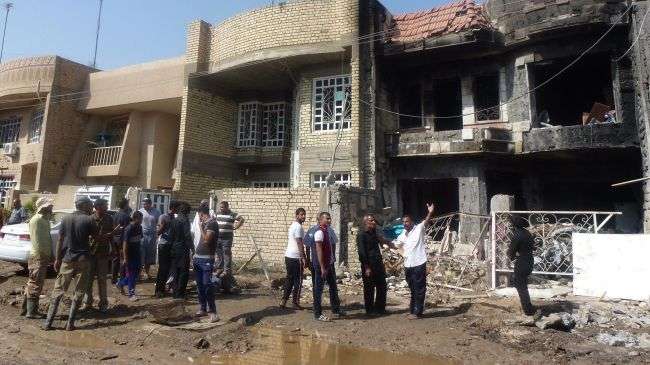 Iraqis inspect the damage from mortar rounds that struck the Chikok neighborhood of Baghdad on October 23, 2012.