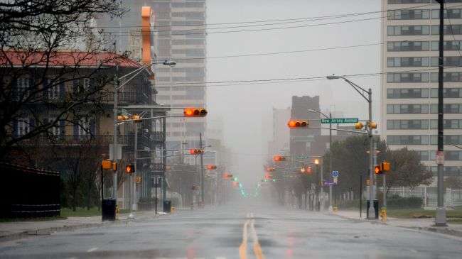 Traffic lights are reflected on the empty Pacific Avenue amid rains prior to the landfall of Hurricane Sandy in Atlantic City, New Jersey, October 29, 2012.