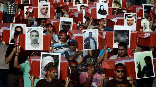 Bahraini protesters carry symbolic coffins with pictures of victims of the government crackdown on ongoing opposition protests in the Shia village of Barbar on the western outskirts of the Bahraini capital Manama on May 4, 2012.
