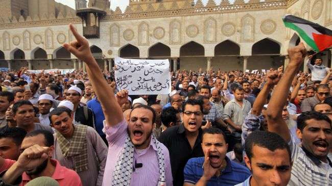 Egyptians shout anti-Israeli slogans during a demonstration in front of Al-Azhar mosque after the weekly Friday prayer in Cairo on November 16, 2012.