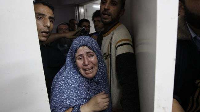 A Palestinian woman grieves at the hospital in Gaza City on November 18, 2012, after seven members of her family were killed in an attack by Israel.
