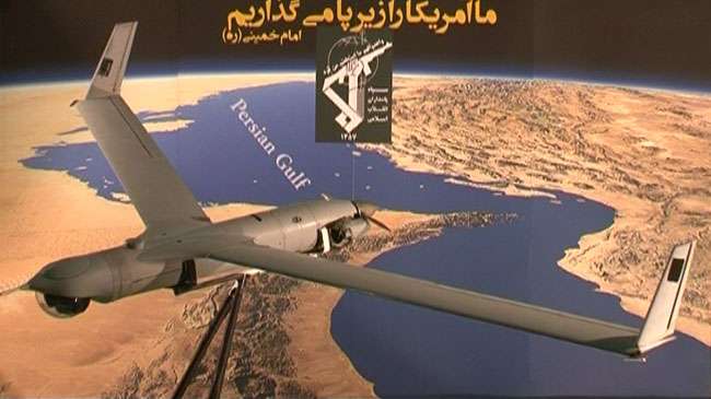 The US ScanEagle drone captured by Iran over the Persian Gulf waters in Iranian airspace is seen on display against the background of a Persian Gulf map, December 4, 2012.