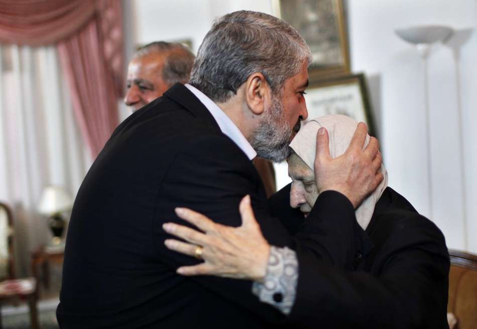 Hamas chief Meshaal kisses the head of Kadejah, the sister of late Palestinian leader Arafat, in Gaza