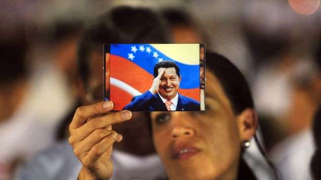 A woman holds a photograph of Hugo Chavez during a ceremony held in Managua to pray for the health of Chavez, on December 09, 2012.