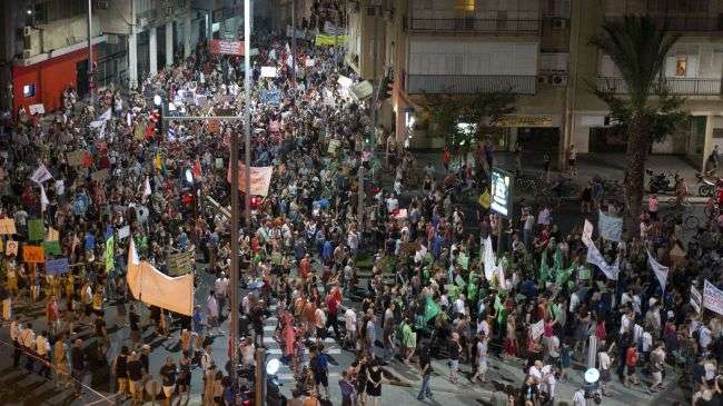 Israeli protesters take part in a demonstration in Tel Aviv on July 14 to protest the spiraling cost of living.