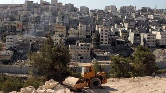 An Israeli bulldozer sits at a construction site in East al-Quds (Jerusalem).