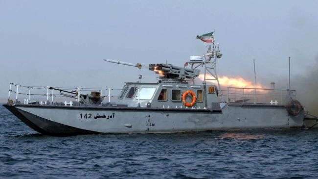 An Iranian military boat fires a missile during the Velayat-90 naval drills in the Strait of Hormuz in southern Iran, December 30, 2011.