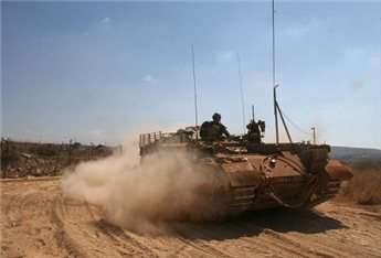 Israeli military vehicles level land inside Gaza