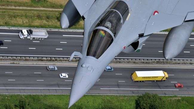 The picture a French Rafale jet flying over a highway during a training between Istres, southern France and Paris ahead of the Bastille day military air parade on July 09 2012.