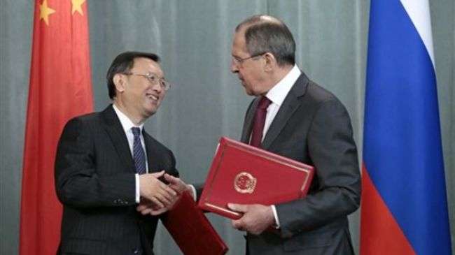 Russian Foreign Minister Sergey Lavrov, right, shakes hands as he exchanges documents after signing with his Chinese counterpart Yang Jiechi during their meeting in Moscow, Russia, Friday, Feb. 22, 2013.