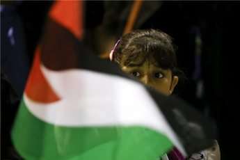 A girl waves a Palestinian flag during a protest.
