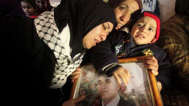 The sisters of Arafat Jaradat (picture), a Palestinian inmate who died in an Israeli prison, mourn their brother’s death during his funeral in the West Bank, February 25, 2013.