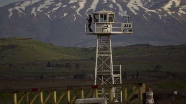 A UN peacekeeper stands guard on a watch tower at the Quneitra Crossing between Syria and the Israeli-occupied Golan Heights on March 8, 2013.