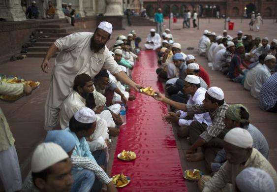 Muslims arrange plates before iftar (breaking fast) meal on the first day of the holy month of Ramadan in India at the Jama Masjid (Grand Mosque) in the old quarters of Delhi July 11 2013.