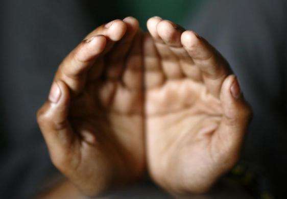 The hands of a Muslim boy are pictured as he offers prayers during the month-long fasting in the holy month of Ramadan in Kathmandu July 11 2013.