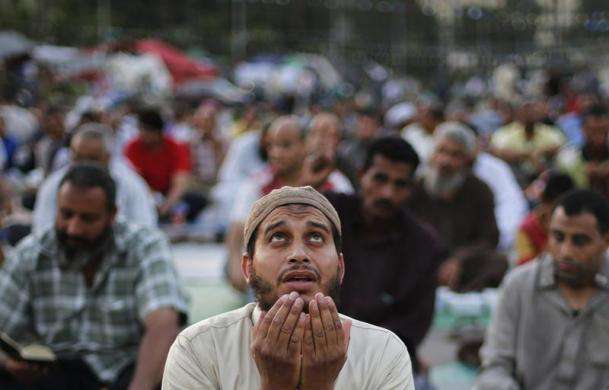 A supporter of the deposed Egyptian President Mohamed Mursi prays before he eats his Iftar meal on the first day of Ramadan during a sit-in in Cairo July 10 2013.