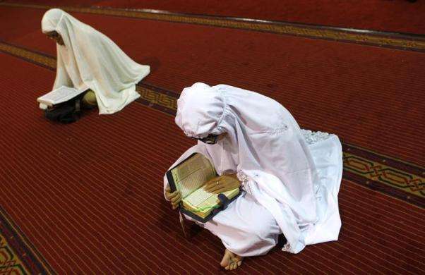 Muslim women read the Quran during the first day of the holy fasting month of Ramadan at Istiqlal mosque in Jakarta July 10 2013.