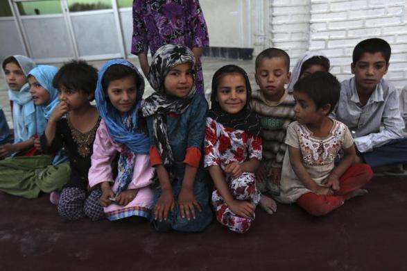 Afghan children wait for Iftar meal on the first day of Ramadan the holiest month in the Islamic calendar at a mosque in Kabul July 10 2013.