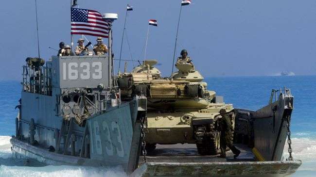 A US Naval ship deploys an Egyptian tank on the coast of Egypt