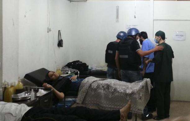 U.N. chemical weapons experts visit a hospital where wounded people affected by an apparent gas attack are being treated in the southwestern Damascus suburb of Mouadamiya August 26 2013.