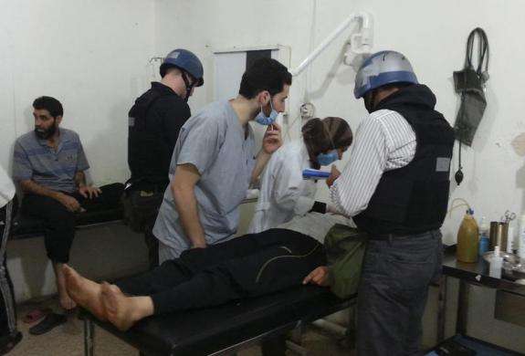 U.N. chemical weapons experts visit people affected by an apparent gas attack at a hospital in the southwestern Damascus suburb of Mouadamiya August 26 2013.